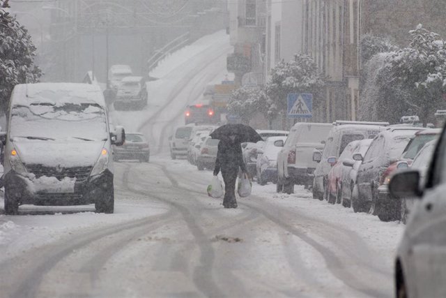 Un hombre camina en medio de una gran nevada en Becerrea, en Lugo, Galicia (España), a 4 de diciembre de 2020. Hoy se ha producido la primera gran nevada del otoño en la montaña lucense. La intensa nevada que está cayendo sobre el centro de la provincia d
