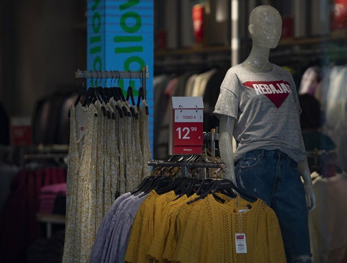 Interior una tienda de la capital con carteles de descuentos y un maniquí con una camiseta donde se puede leer "rebajas", durante el segundo día de rebajas, en Madrid (España), a 26 de junio de 2020.