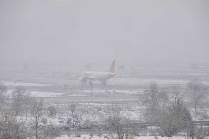 Un avión de la compañía Flypgs en el Aeropuerto de Madrid-Barajas Adolfo Suárez, en Madrid (España), a 8 de enero de 2021. El temporal de nieve y las heladas han obligado al aeropuerto a descongelar más de 60 aviones esta mañana. Aena ha activado el Pla
