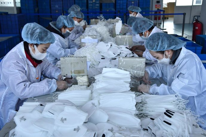 12 February 2020, China, Hebei: workers produces surgical masks at a production line manufacturing masks at a factory, amid the ongoing coronavirus crisis. Photo: Hu Gaolei/SIPA Asia via ZUMA Wire/dpa