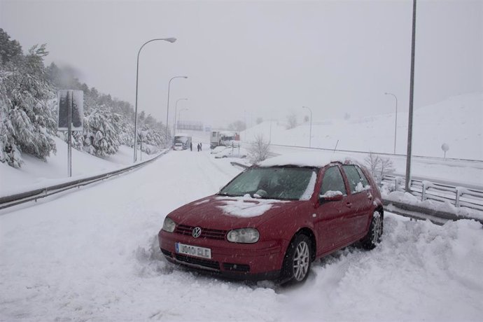 Un vehículo atrapado por la nieve en una de las carreteras de acceso al distrito de Hortaleza, en Madrid
