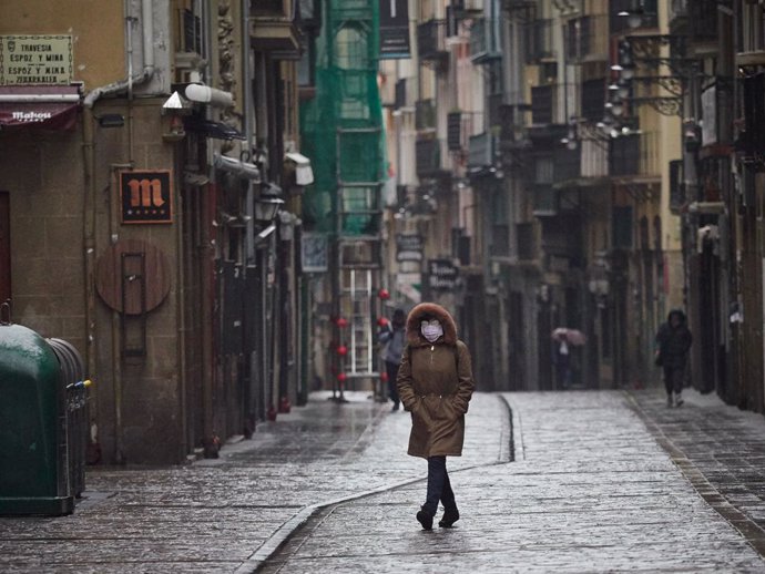 Una mujer camina protegida con una mascarilla por la Calle Estafeta. En Pamplona (Navarra, España) a 31 de marzo de 2020.