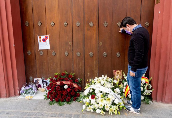 En la puerta de la Iglesia del Baratillo se acumulan ramos de flores y  algunos fieles debido a la suspensión de la Semana Santa de Sevilla por el estado de alarma con el coronavirus COVID-19, foto de archivo