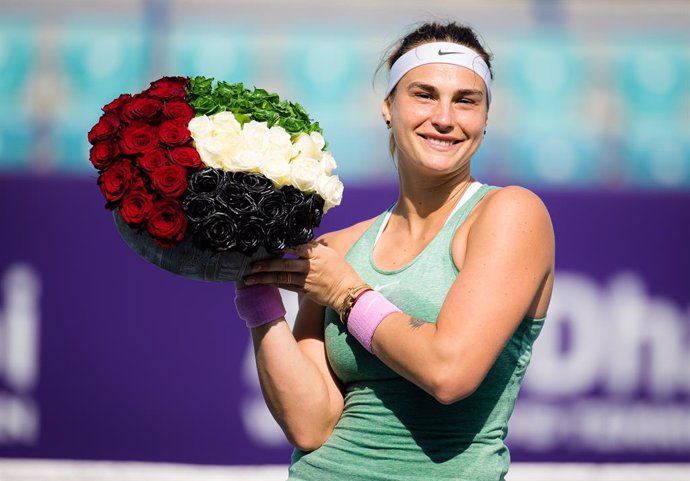 Aryna Sabalenka of Belarus poses with flowers after winning the final of the 2021 Abu Dhabi WTA Womens Tennis Open WTA 500 tournament against Veronika Kudermetova of Russia