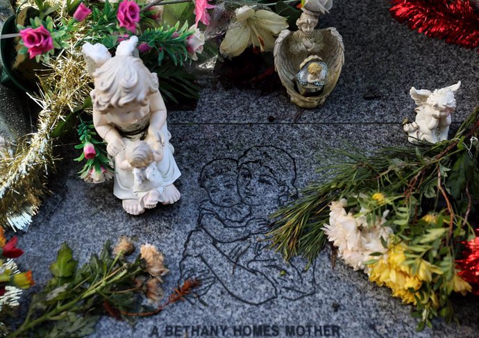13 January 2021, Ireland, Dublin: Flowers and figurines lie at the memorial to to 222 children from the Bethany Mother and Child Home, at Mount Jerome Cemetery, as Irish Prime Minister Micheal Martin is to apologise to survivors of homes for unmarried m