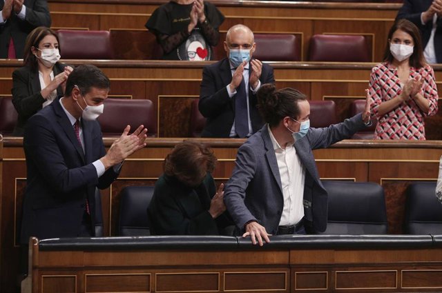 El presidente del Gobierno, Pedro Sánchez (i), acompañado de otros miembros del partido aplauden al vicepresidente segundo del Gobierno, Pablo Iglesias