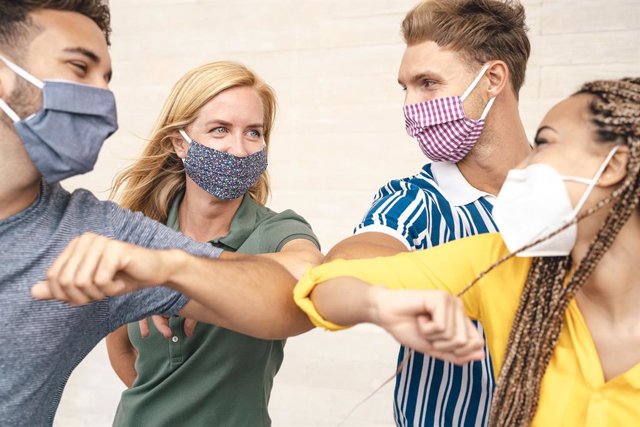 Canarias registra 357 nuevos casos en las últimas 24 horas y tiene que lamentar 4 muertes más Amigos con mascarilla saludándose con el codo.