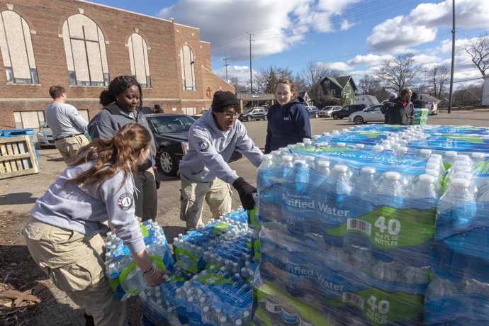 Voluntarios reparten agua embotellada en la ciudad de Flint. 