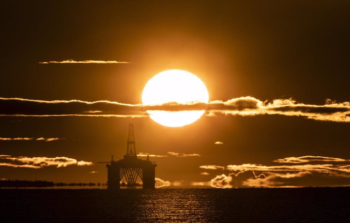 27 April 2020, Scotland, Kirkcaldy: The sun rises behind a redundant oil platform moored in the Firth of Forth near Kirkcaldy. Photo: Jane Barlow/PA Wire/dpa