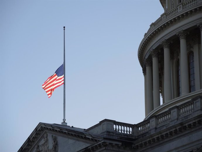 09 January 2021, US, Washington: A US flag flies at half-mast at the US Capitol in memory of police officer Brian Sicknick. Sidnick died as a result of injuries sustained during a riot by pro-Trump supporters who stormed and vandalized the Capitol on We