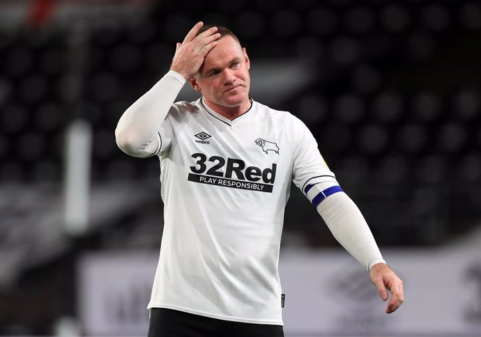 FILED - 16 October 2020, England, Derby: Derby County's Wayne Rooney in action during the Sky Bet Championship socer match between Derby County and Watford at Pride Park. Former England captain Wayne Rooney said Monday he had tested negative for the cor