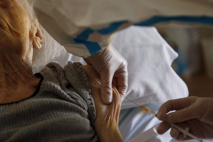 13 January 2021, Italy, Rome: An elderly woman receives her dose of the Biontech/Pfizer COVID-19 vaccine at a retirement Home. Photo: Cecilia Fabiano/LaPresse via ZUMA Press/dpa