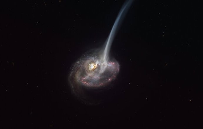 La impresión de este artista de ID2299 muestra la galaxia, producto de una colisión galáctica, y parte de su gas es expulsado por una "cola de marea" como resultado de la fusión.
