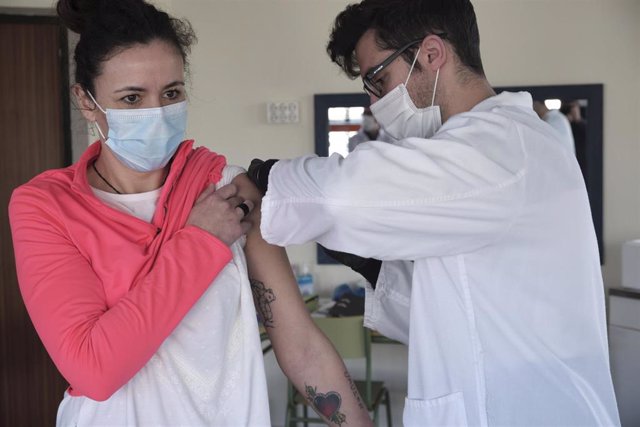 Un trabajador sanitario inyecta una de las primeras vacunas de Pfizer-BioNTech contra la Covid-19 a una trabajadora de la Vivienda Tutelada para personas discapacitadas de Campo de Criptana, en el Centro Ocupacional Rogelio Sánchez Ruiz, Campo de Criptana