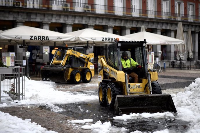 Dos máquinas excavadoras continúan con las tareas de limpieza de calles tras la gran nevada provocada por la borrasca Filomena, en la Plaza Mayor, Madrid (España), a 20 de enero de 2021. Filomena dejó paso ayer al temporal de lluvias 'Gaetán' que co