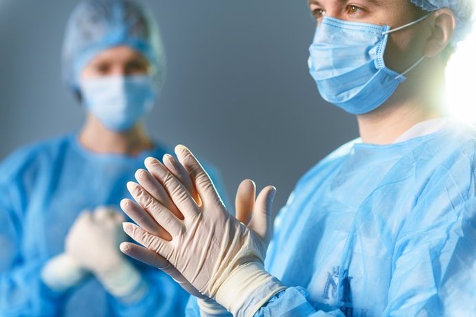 Concentrated doctors dressed in surgical uniform