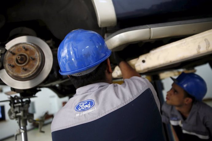 The corporate logo of Ford is seen on the uniform of a mechanic at a Ford branch in Caracas March 27, 2015. The Venezuela division of Ford Motor Company in the coming months will begin selling vehicles only in dollars, two sources familiar with the situ