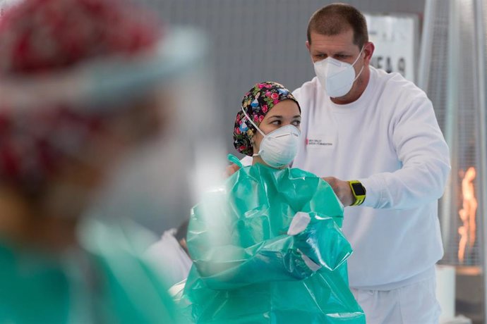 Una trabajadora sanitaria se protege para realizar tests de antígenos.