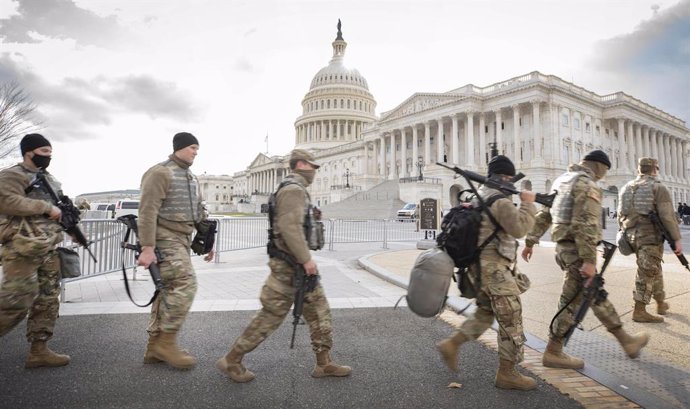 Miembros de la Guardia Nacionall pasan frente al Capitolio. 