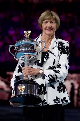 Margaret Court is presented with a replica trophy during a ceremony to mark the 50th anniversary of her Grand Slam win, on day eight of the Australian Open tennis tournament at Rod Laver Arena in Melbourne, Melbourne, Monday, January 27, 2020. (AAP Imag