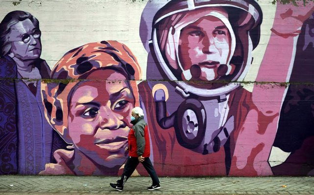 Un hombre pasa por el mural feminista en el polideportivo municipal de la Concepción 
