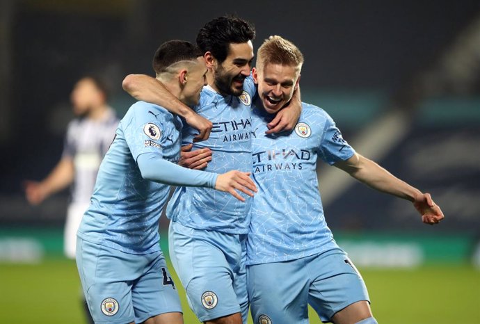 26 January 2021, United Kingdom, West Bromwich: Manchester City's Ilkay Gundogan (C) celebrates scoring his side's first goal with his team mates Phil Foden (L) and Alexander Zinchenko during the English Premier League soccer match between West Bromwich