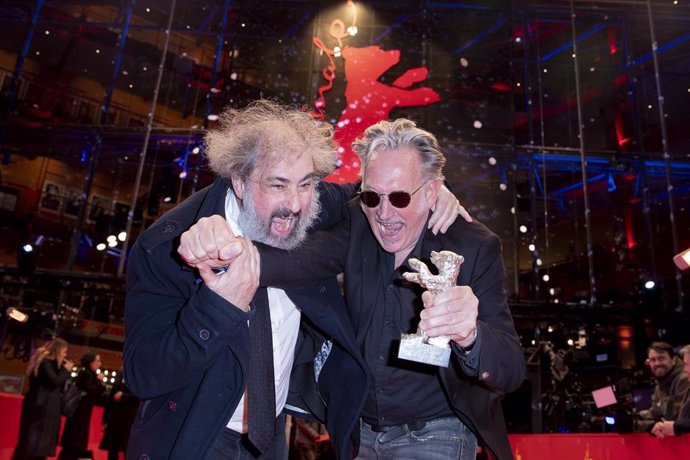 29 February 2020, Berlin: French directors Gustave Kervern (L) and Benoit Delepine (R) and react after receiving The Silver Bear during the 70th Berlinale International Film Festival. Photo: Christoph Soeder/dpa