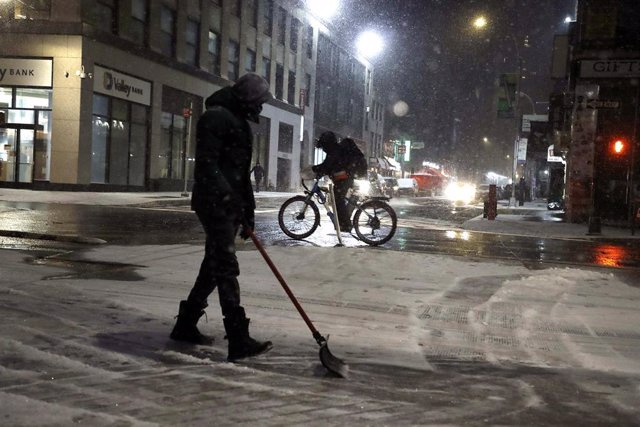 Un hombre despeja de nieve una de las calles de Nueva York.