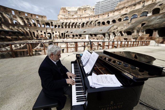 01 February 2021, Italy, Rome: A pianist performs during the soundcheck rehearsal for the reopening celebration of the Colosseum, which will reopen to the public on Monday 1 February 2021 after a closure of almost three months, as Italy relaxes its coro