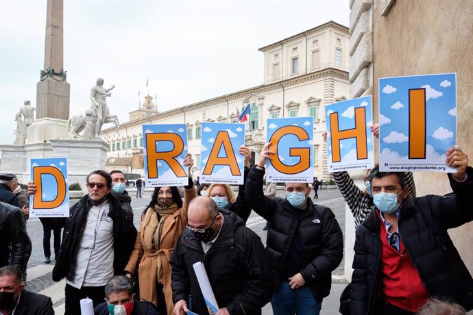 03 February 2021, Italy, Rome: Supporters of former President of the European Central Bank Mario Draghi hold placards upon his arrival at the Quirinal Palace for a meeting with Italian President Sergio Mattarella for consultations to form a new governme