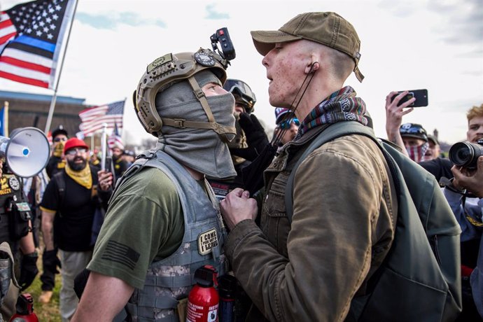 12 December 2020, US, Washington Dc: A member of the the far-right, neo-fascist and male-only political organization "Proud Boys" clashes with another member of the left-wing anti-fascist political movement "Antifa" during a protest in support of Presid