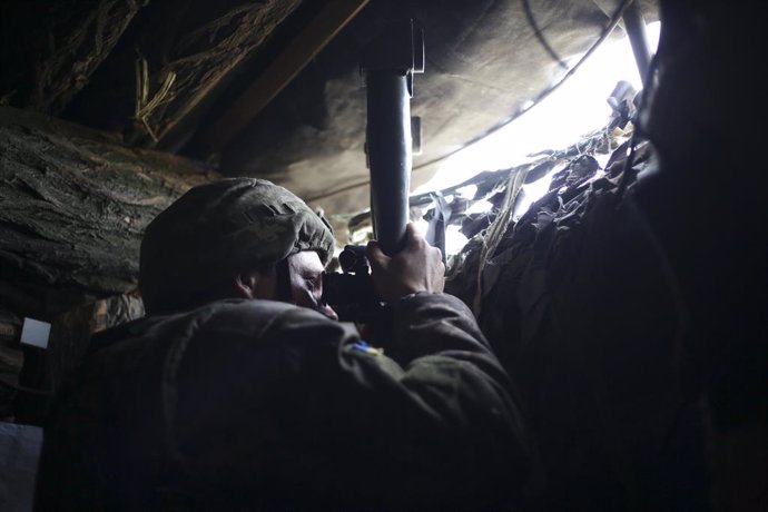 May 10, 2019 - Avdiivka, Ukraine: An Ukrainian soldier looks through a periscope in an observation bunker on the front lines. The soldiers said Donetsk People's Republic positions were about 300 meters in front of them, across a grassy field covered in 