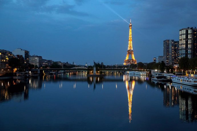 12 April 2020, France, Paris: The Eiffel Tower is reflected on the Seine river. Photo: Ludovic Marin/AFP/dpa