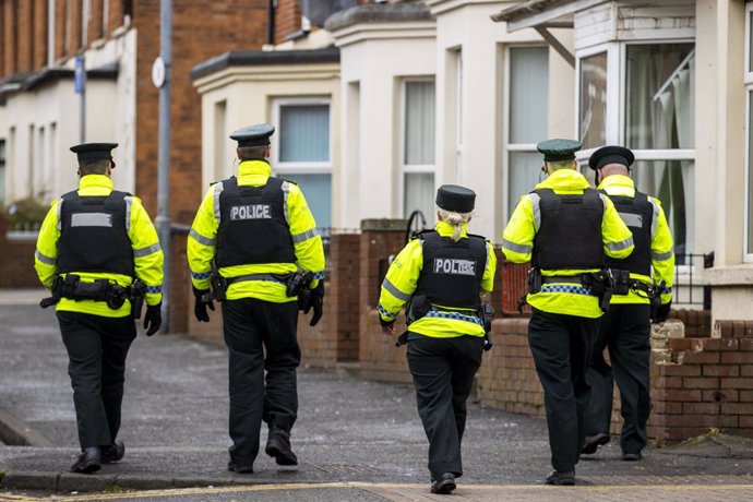 17 March 2020, Northern Ireland, Belfast: Police Service of Northern Ireland (PSNI) officers patrol the student area of Belfast known as the Holylands on St Patrick's Day. Due to Coronavirus Belfast City Council cancelled the festivities for the safety 