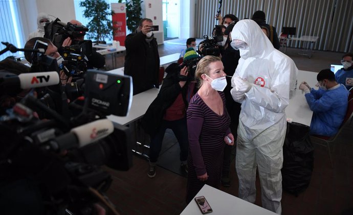 03 February 2021, Austria, Vienna: A health worker takes a swab from a woman for Coronavirus test at the new Corona test centre near Schoenbrunn Palace. Photo: Helmut Fohringer/APA/dpa