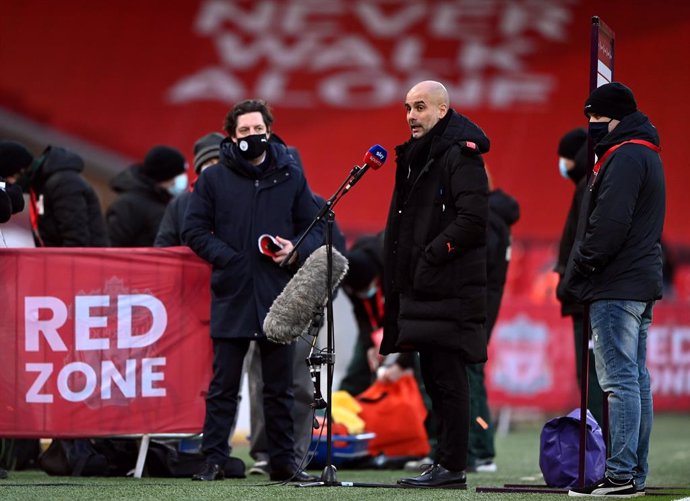 07 February 2021, United Kingdom, Liverpool: Manchester City manager Pep Guardiola gives and interview before the start of the English Premier League soccer match between Liverpool and Manchester City at Anfield. Photo: Laurence Griffiths/PA Wire/dpa