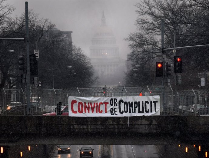 11 February 2021, US, Washington: A general view of a protest sign hangs on the overpass of the Capitol Street as the historic second impeachment trial continues against former USPresident Donald Trump. Photo: Carol Guzy/ZUMA Wire/dpa