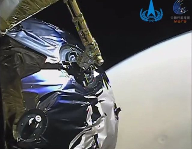 Tianwen 1 durante la inserción orbital en Marte. En la imagen se aprecia un cráter en la superficie.