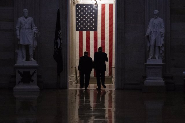 2/9/2021 - Washington, District of Columbia, United States of America: United States Senator Chris Coons (Democrat of Delaware), left, and United States Senator Mark Warner (Democrat of Virginia), right, walk through the Capitol Rotunda at the end of th