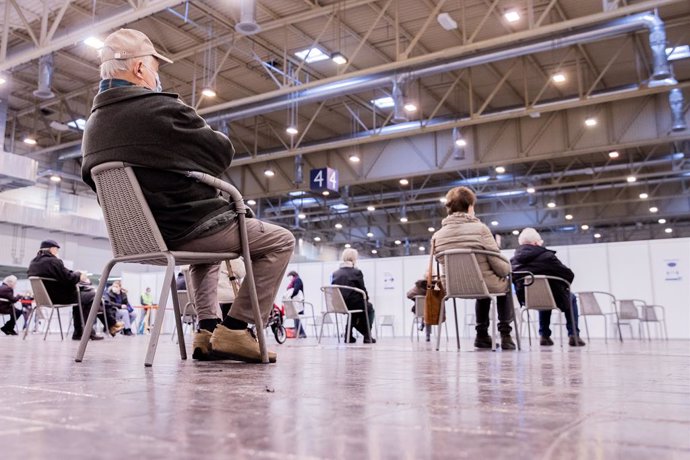 08 February 2021, North Rhine-Westphalia, Essen: People sit at the waiting area of a vaccination centre before receiving their COVID-19 jabs during a campaign to vaccinate people over 80 years of age. Photo: Rolf Vennenbernd/dpa