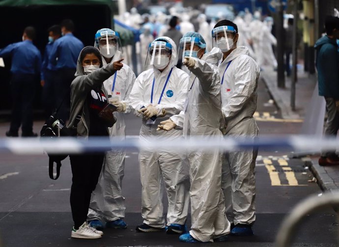 23 January 2021, China, Hong Kong: Sanitizing Team prepare to work in Yau Tsim Mong district where unprecedented lockdown has been declared early this morning by Hong Kong government in order to carry out compulsory coronavirus (Covid-19) testing in the