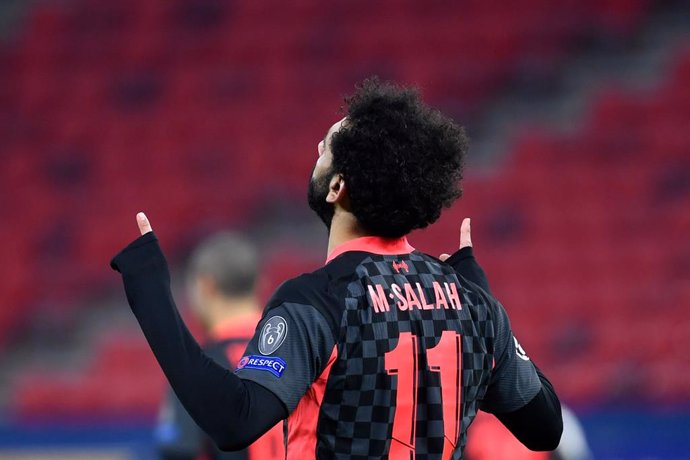 16 February 2021, Hungary, Budapest: Liverpool's Mohamed Salah celebrates scoring his side's first goal during the UEFAChampions League round of 16 first leg soccer match between RB Leipzig and FC Liverpool at Puskas Arena. Photo: Marton Monus/dpa