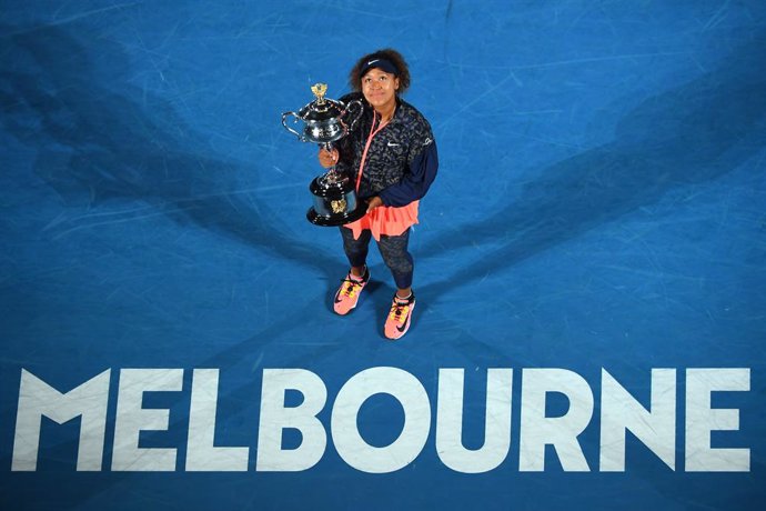 Naomi Osaka of Japan holds the trophy after winning the women's singles final against Jennifer Brady of the United States on day 13 of the Australian Open tennis tournament at Rod Laver Arena in Melbourne,, Saturday, February 20, 2021. (AAP Image/James 