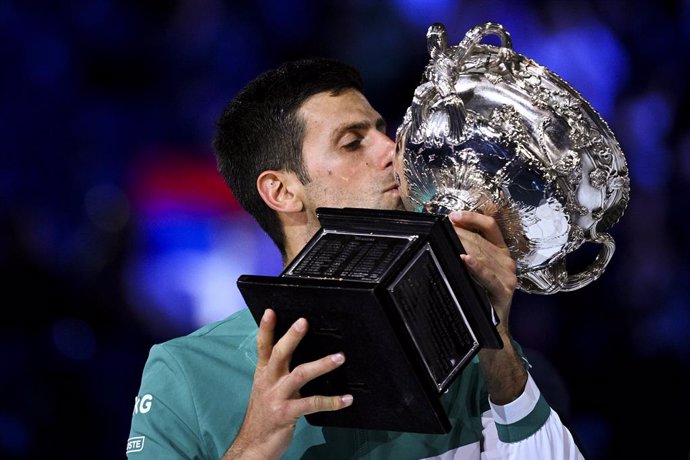 Novak Djokovic of Serbia kisses the Norman Brooks Challenge Cup after winning his Men's singles finals match against Daniil Medvedev of Russia on Day 14 of the Australian Open at Melbourne Park in Melbourne, Sunday, February 21, 2021. (AAP Image/Dean Le