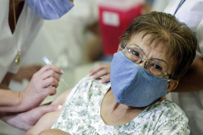 18 February 2021, Argentina, Tucuman: An elderly woman receives a dose of Covid-19 vaccine at the launch of a Covid-19 vaccination campaign for people over 70. Photo: Adrian Lugones/telam/dpa