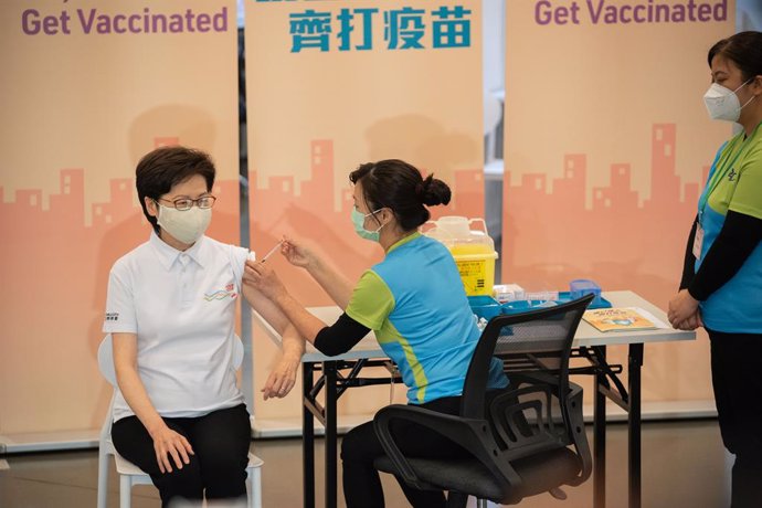 22 February 2021, China, Hong Kong: Hong Kong Chief Executive Carrie Lam (L) receives a dose of a COVID-19 vaccine at the Community Vaccination Centre at the Hong Kong Central Library. Photo: Geovien So/SOPA Images via ZUMA Wire/dpa