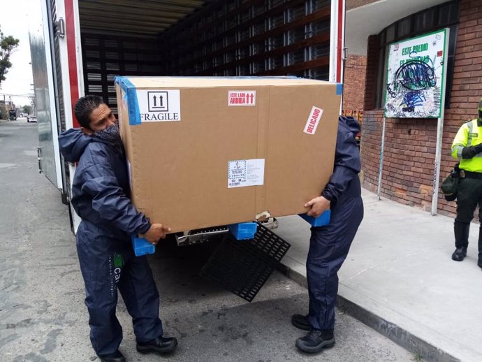 23 February 2021, Colombia, Bogota: Workers unload a delivery of vaccine from the Sinovac laboratory against Covid-19. Photo: Mariano Vimos/colprensa/dpa