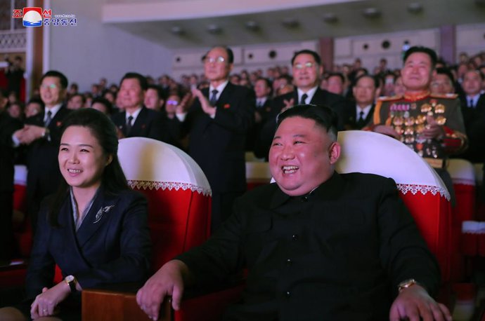 16 February 2021, North Korea, Pyongyang: A photo released by the Korean Central News Agency shows North Korean Leader Kim Jong-un (R) and his wife Ri Sol Ju watching a performance at the Mansudae Art Theater to mark the birthday of Kim's father, Kim Jo