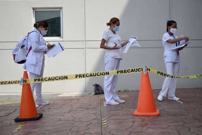 18 February 2021, Mexico, Tuxtla Gutierrez: Nurses stand in a line to apply for the second dose of the coronavirus vaccine in the state of Chiapas. Photo: -/El Universal via ZUMA Wire/dpa