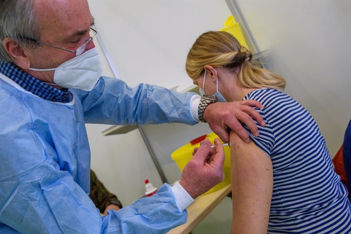 26 February 2021, Saxony-Anhalt, Burg: A health worker vaccinates a teacher with the AstraZeneca COVID-19 vaccine at the Jerichower Land vaccination center. Photo: Klaus-Dietmar Gabbert/dpa-Zentralbild/dpa